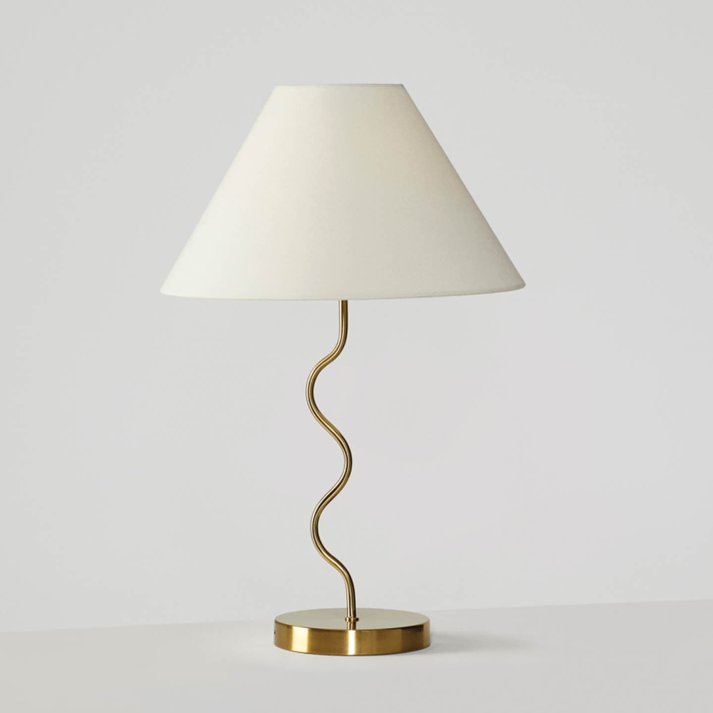 table lamp with a squiggly body and classic shade