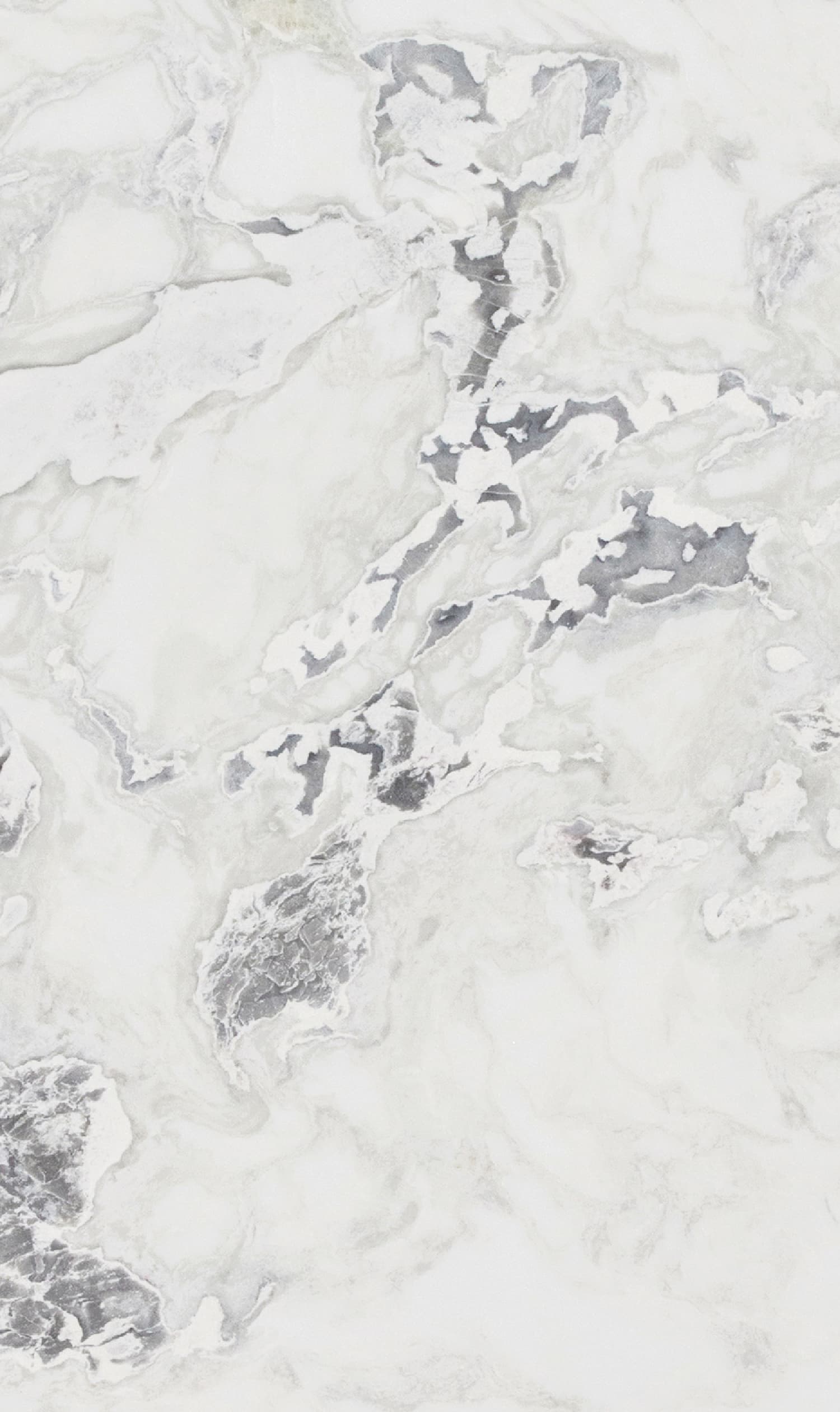 Close-up of Antolini Dover White marble slab featuring soft gray veining on a creamy base.