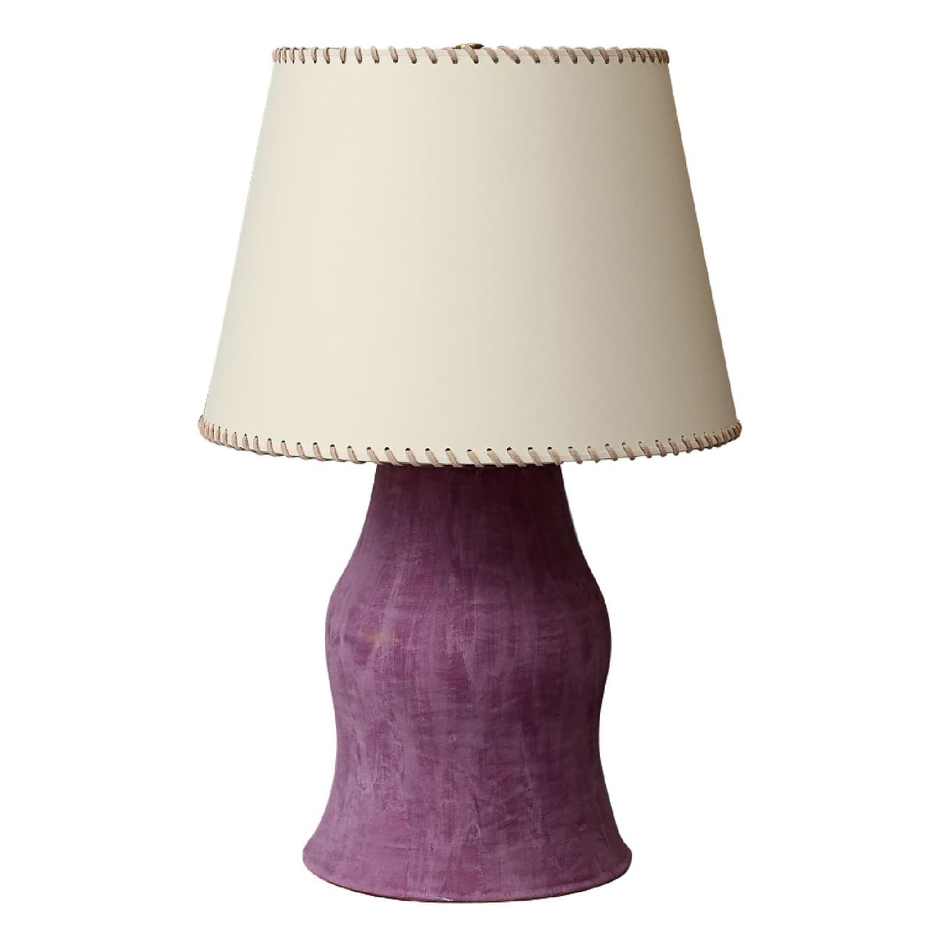 Table lamp with sculptural purple ceramic base and stitched cream lampshade.