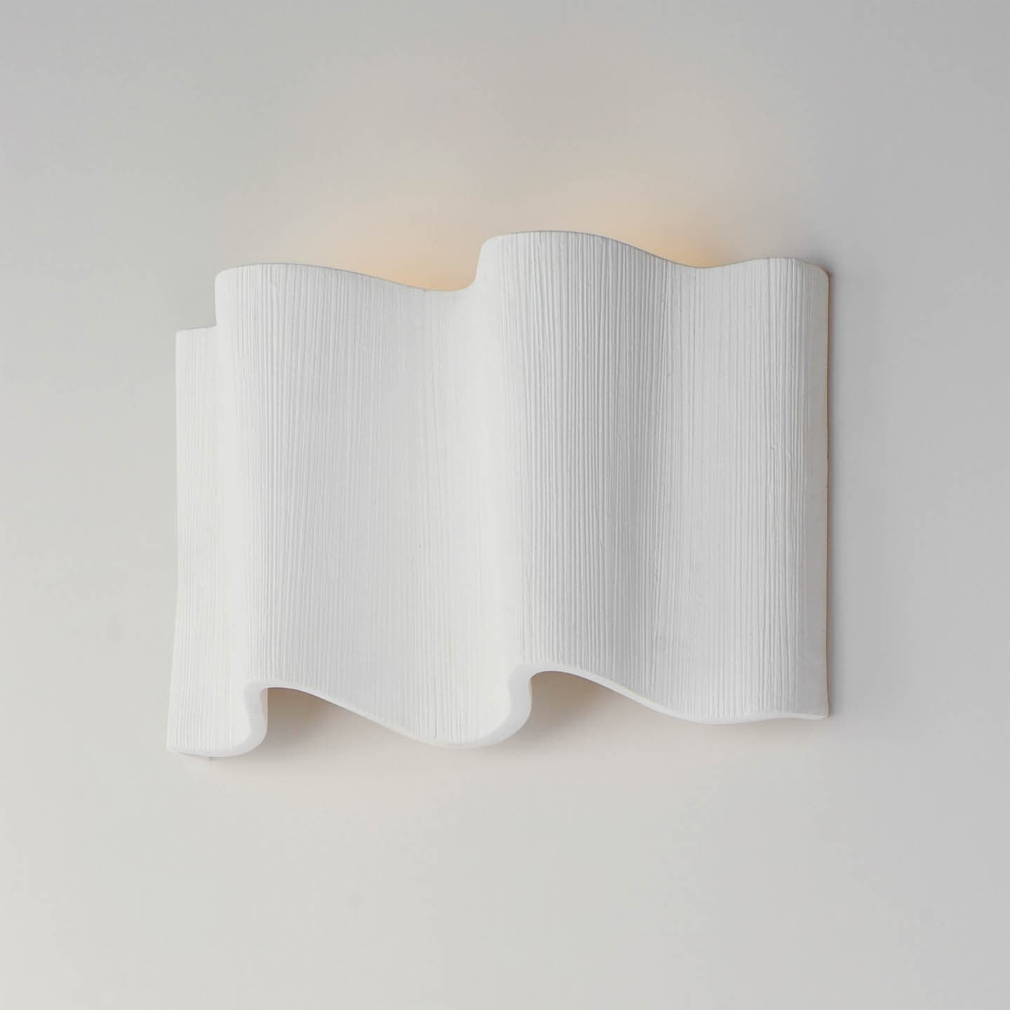 wall sconce shaped like a ruffled white curtain