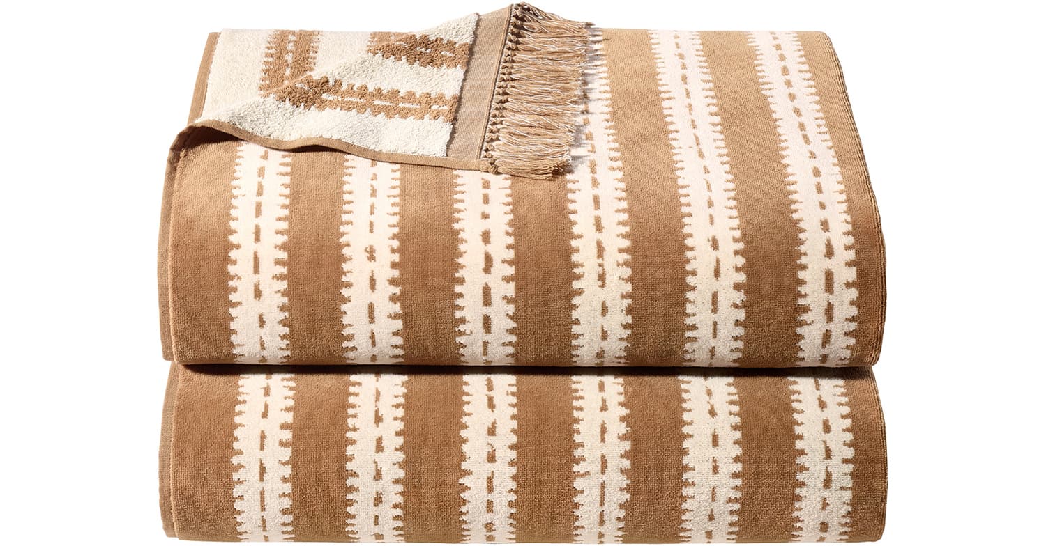 RH x Marcesa’s Nazare Vistula beach towel in camel, featuring a woven geometric pattern and fringed edge.