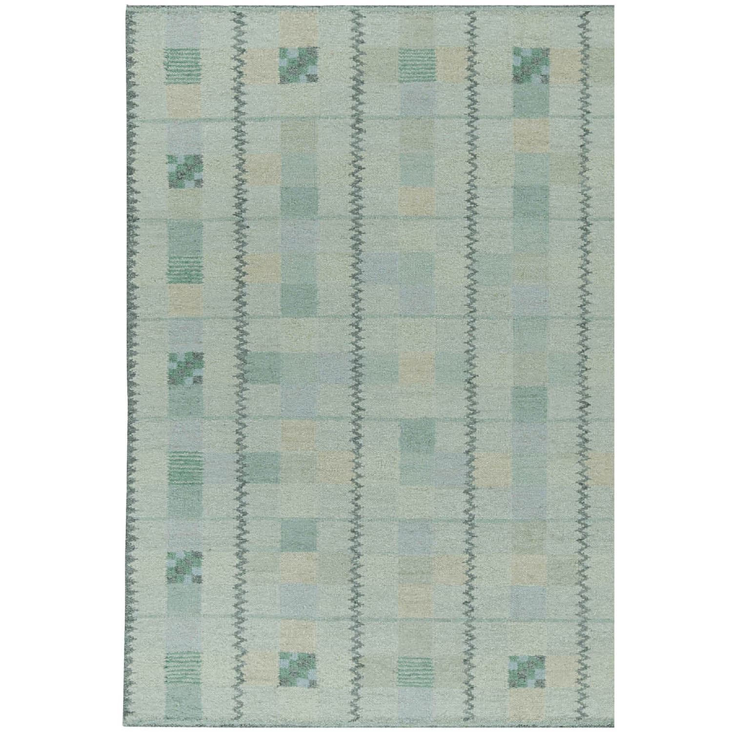 Green geometric rug with subtle checkerboard pattern and vertical zigzag stripes. Squares feature muted tones of green and tan, creating a calm, earthy vibe.