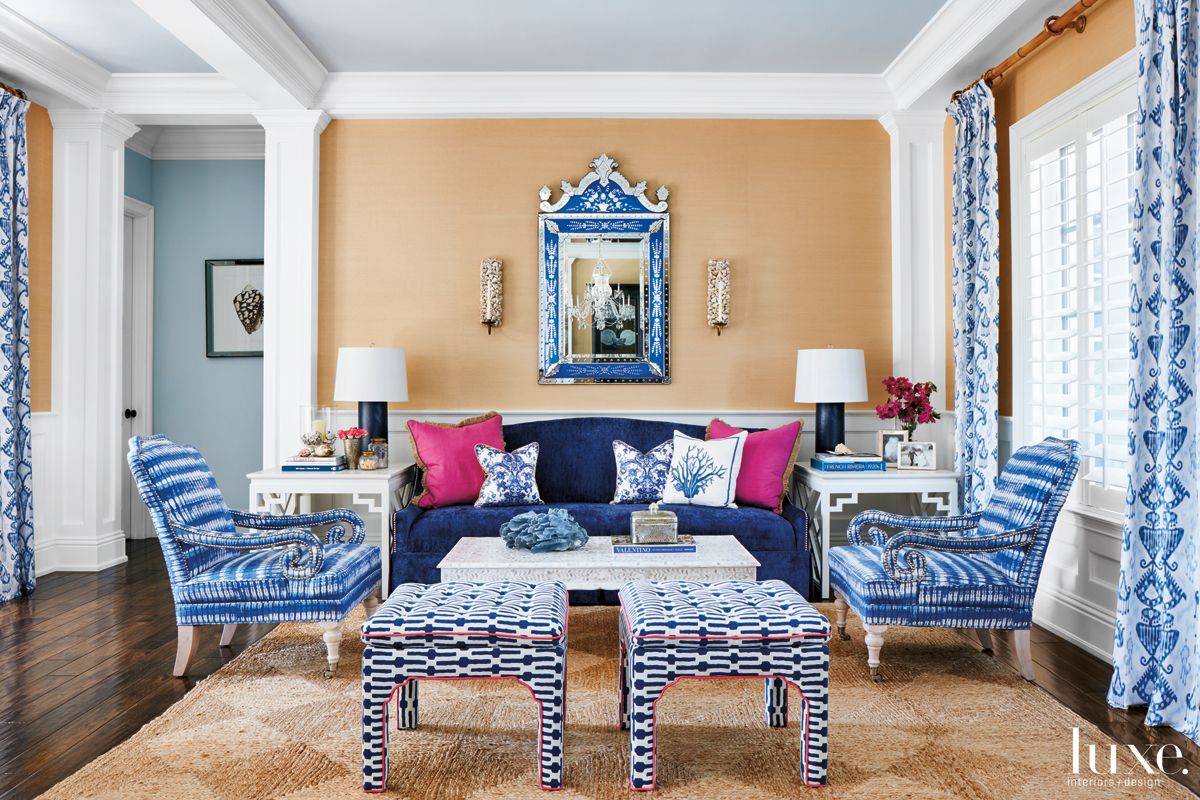 living room with mainly blue furnishings and pink pillows