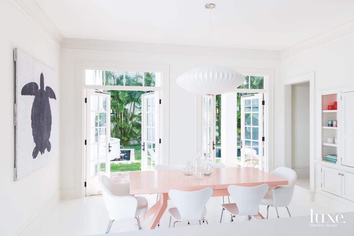 white dining room with long pink dining table