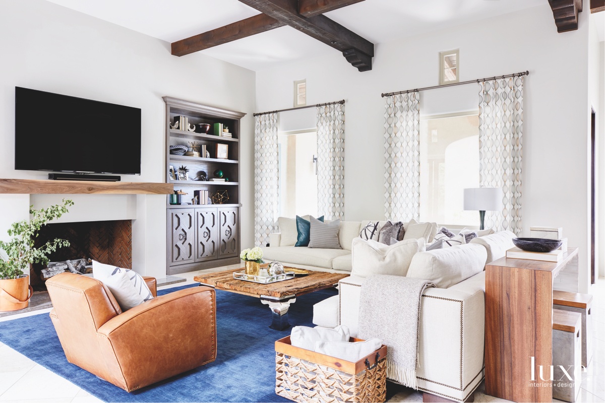 modern living room blue rug walnut shelf white sectional