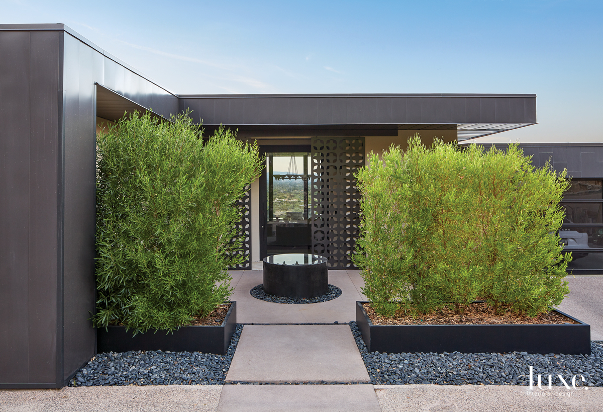 black exterior of home by GM Hunt Builders and shrubbery