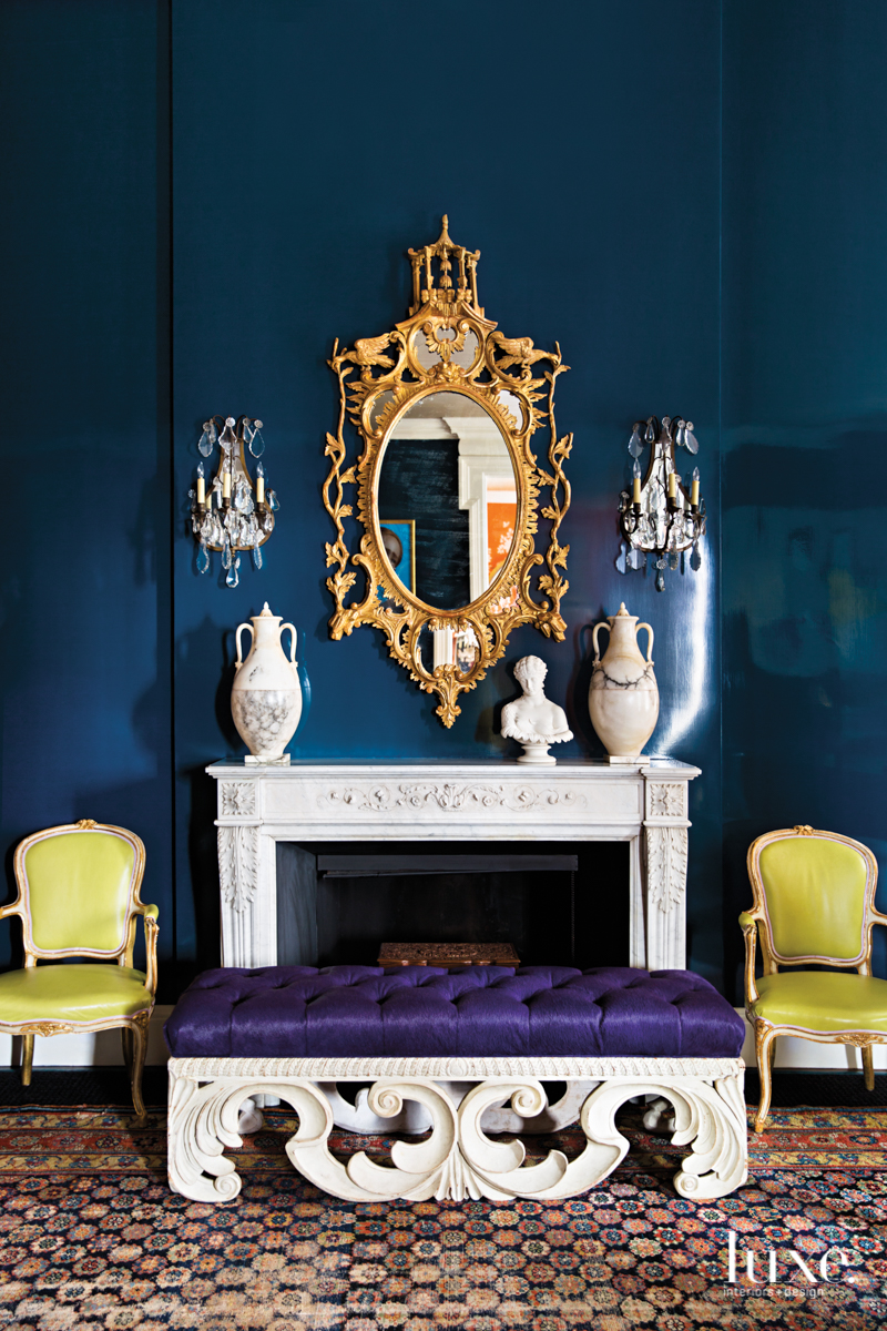 This blue living room with white desk and golden mirror are one of many maximalist interiors