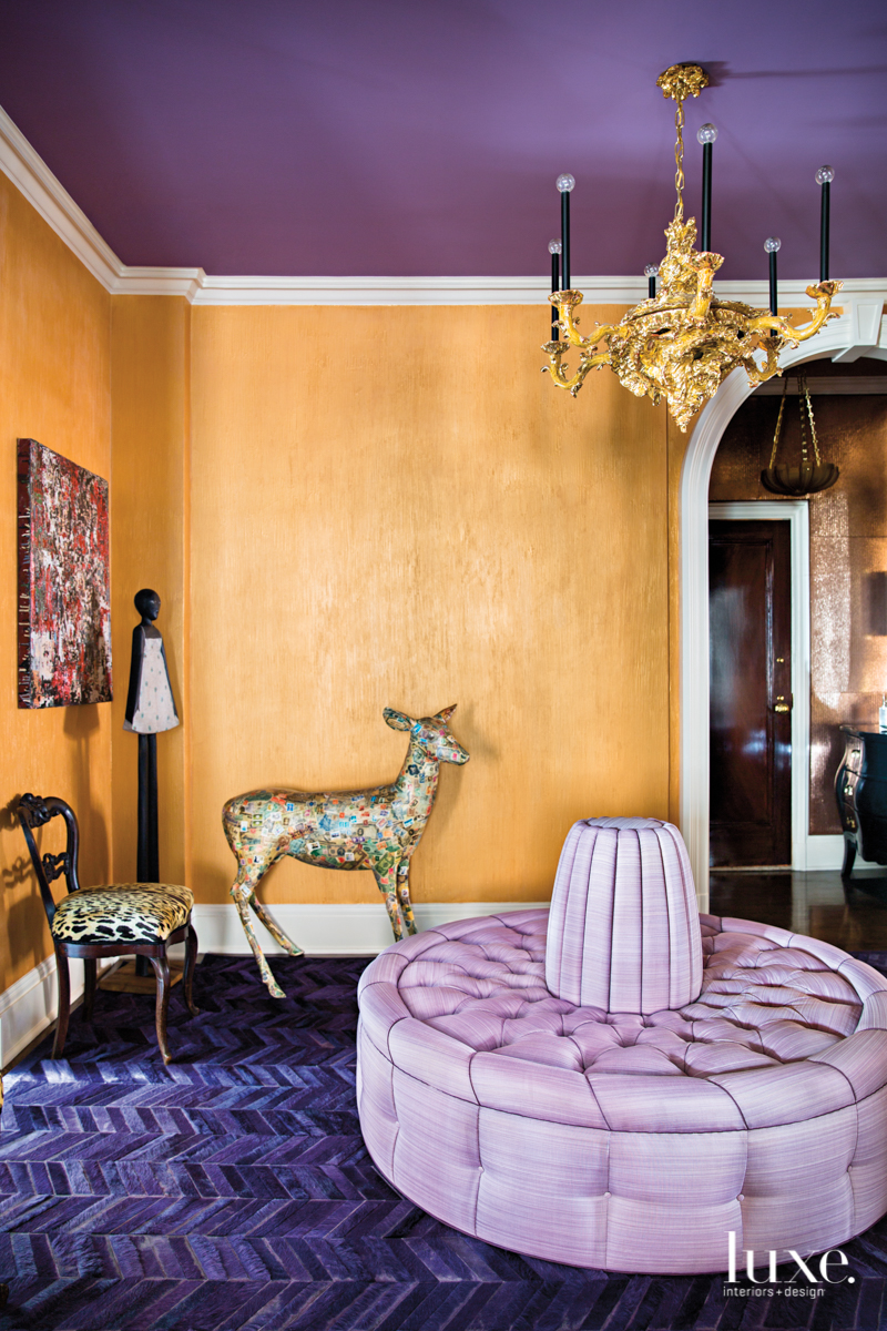 orange room with lavender ottoman and deer statue