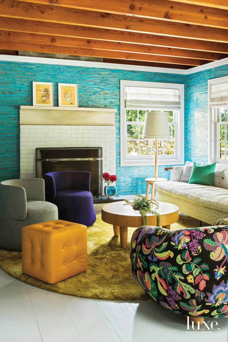 light blue living room with white mantel and patterned armchair