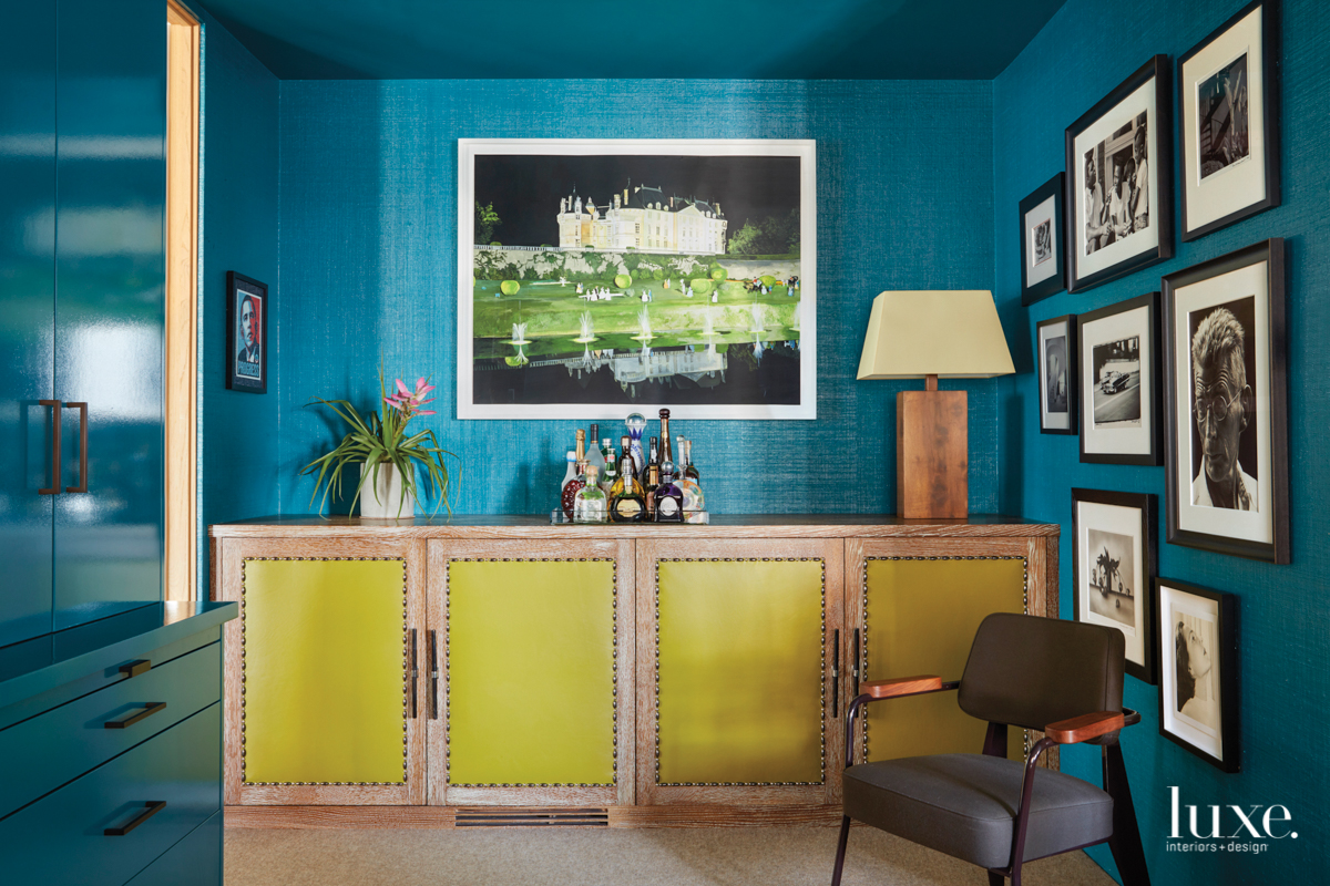 room with teal grasscloth wallpaper and chartreuse oak cabinet