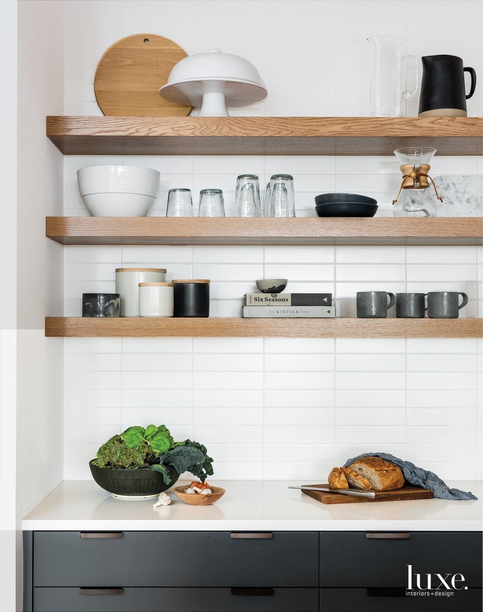 contemporary kitchen black cabinetry white tile backsplash