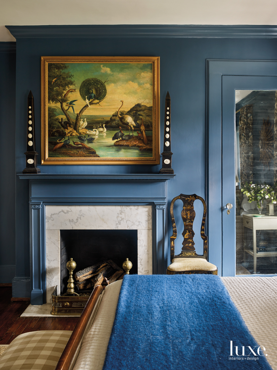blue bedroom with english oil painting and antiques
