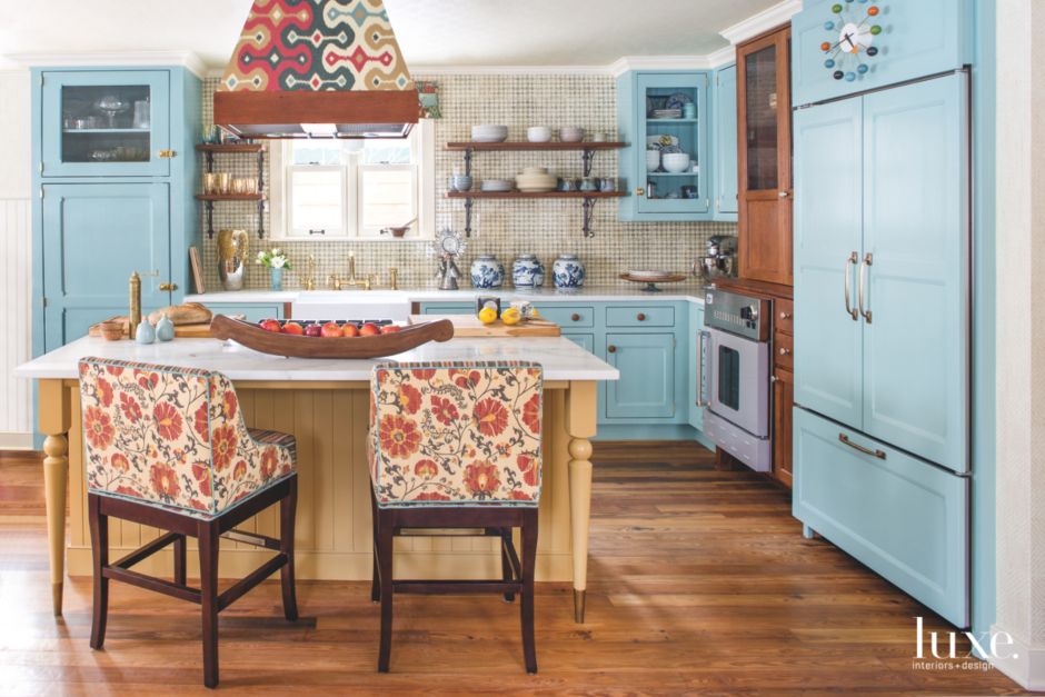 baby blue cabinetry with floral chairs and yellow dining table