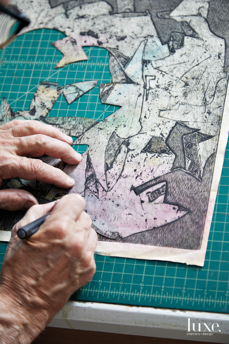The artist cuts shapes that will be layered in his works.