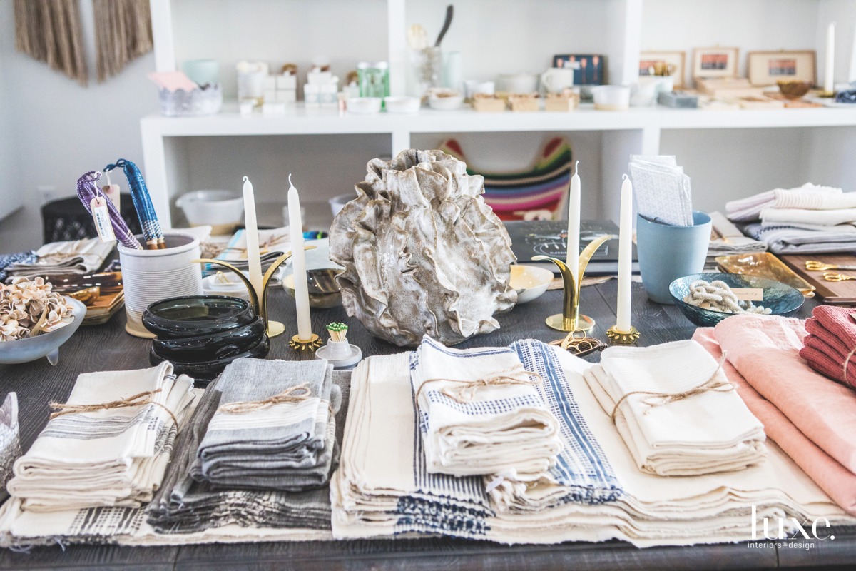 Linens handwoven in Ethiopia are paired with sculptural pottery by Caroline Blackburn Ceramics in California.