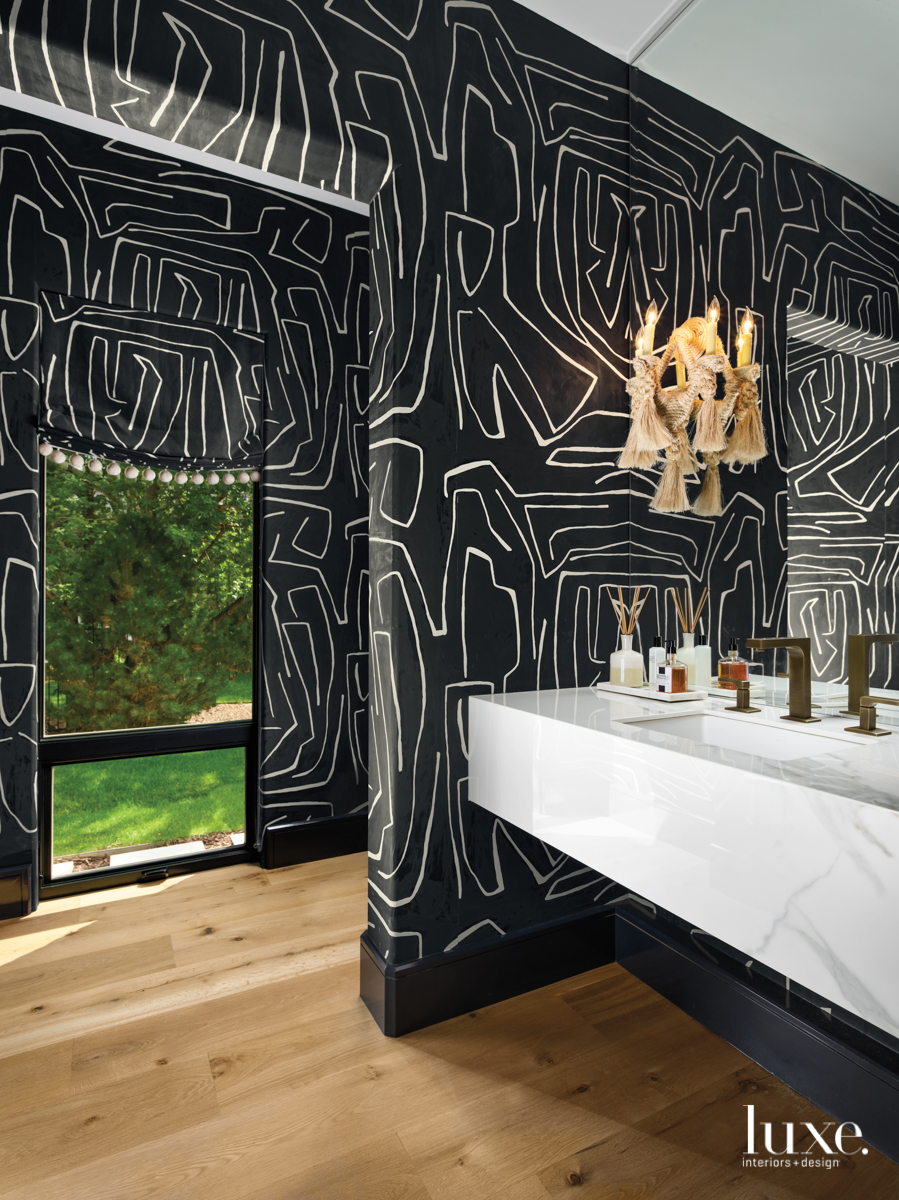 transitional black bathroom with patterned...
