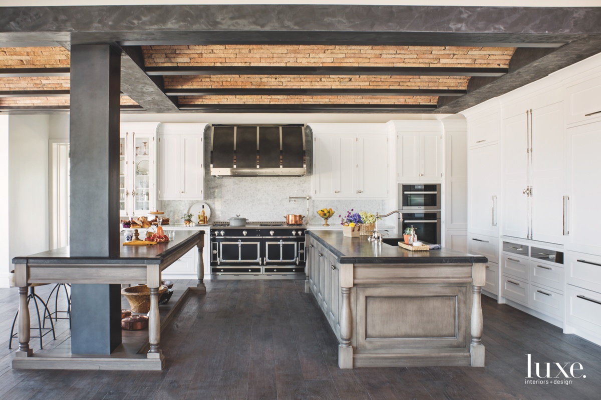 In this Los Angeles kitchen collaboration by Cooper Pacific Kitchens and Pauline Moghavem Interiors, the brick barrel-vault ceiling brings an old-world feel to the mix of otherwise contemporary finishes, from the stainless steel of the Miele wall ovens and the polished-nickel hardware to the Black Phantom leathered-stone countertops and the custom-finished cherry islands.