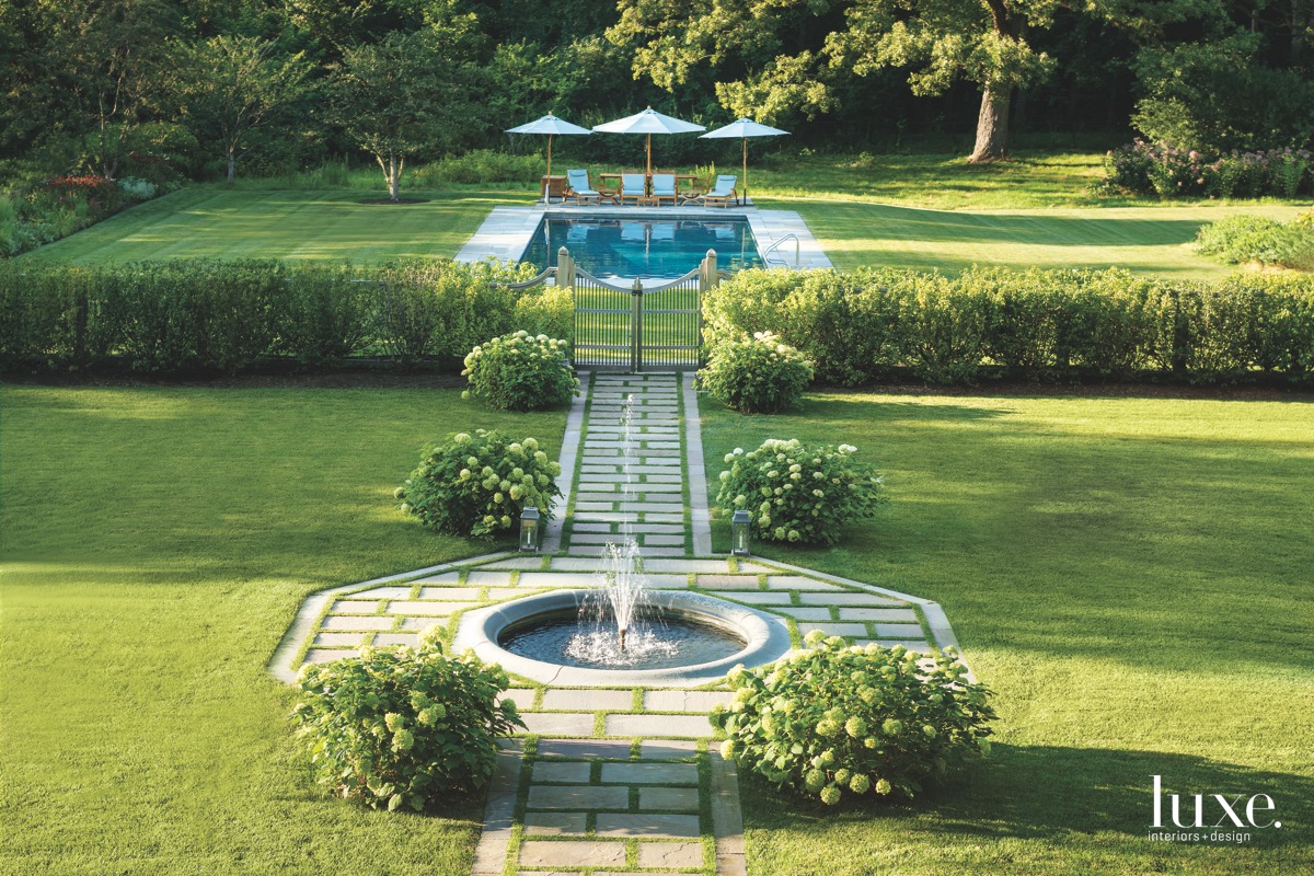 Symmetry reigns in this Lake Forest, Illinois, garden by Hoerr Schaudt. "The strong central axis leads one's eye past an octagonal fountain, through an ornamental gate to the swimmwing pool and woodland beyond," says Douglas Hoerr, CEO and senior principal at the firm.