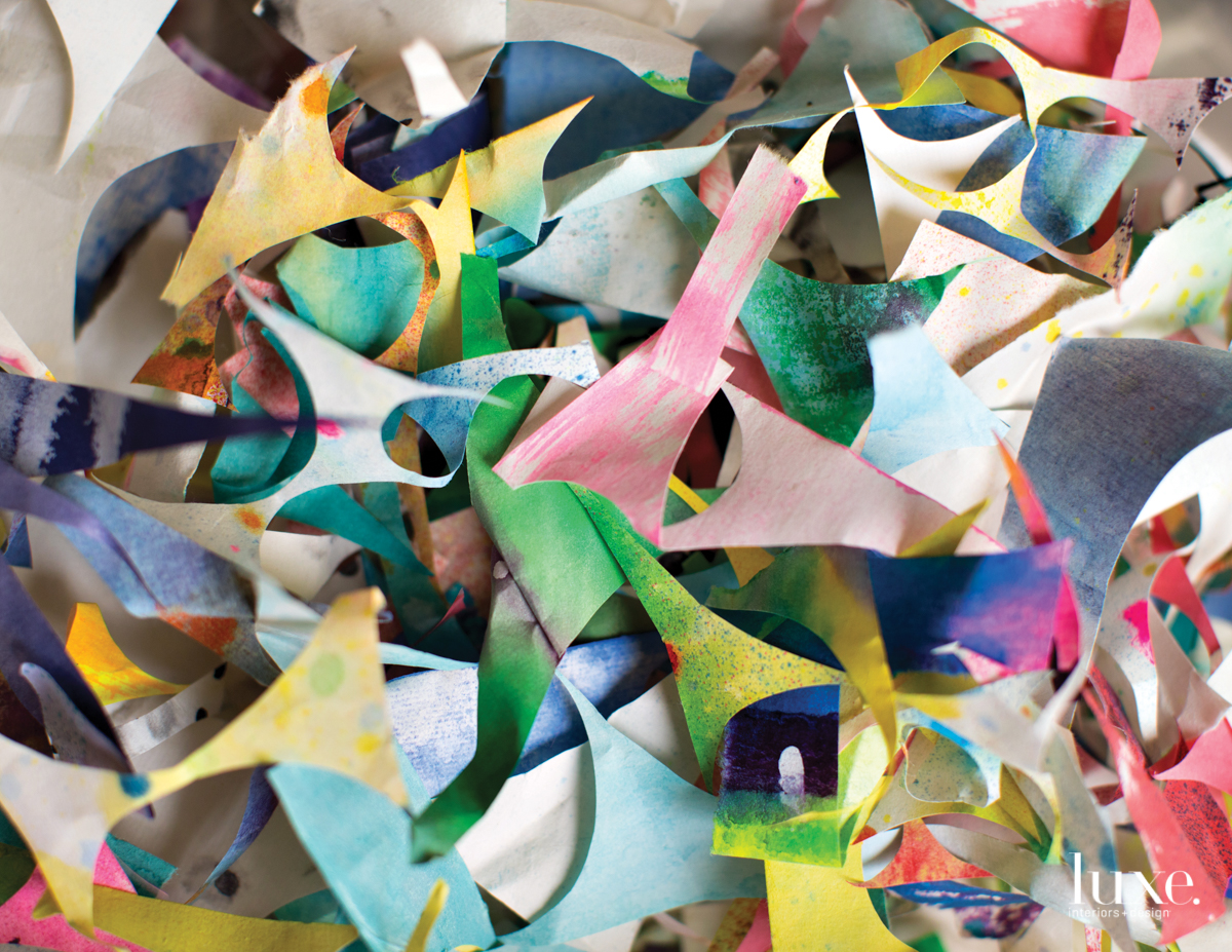 "I cut thousands of circles a year for my work," says Tran of the scraps she often uses for collages.