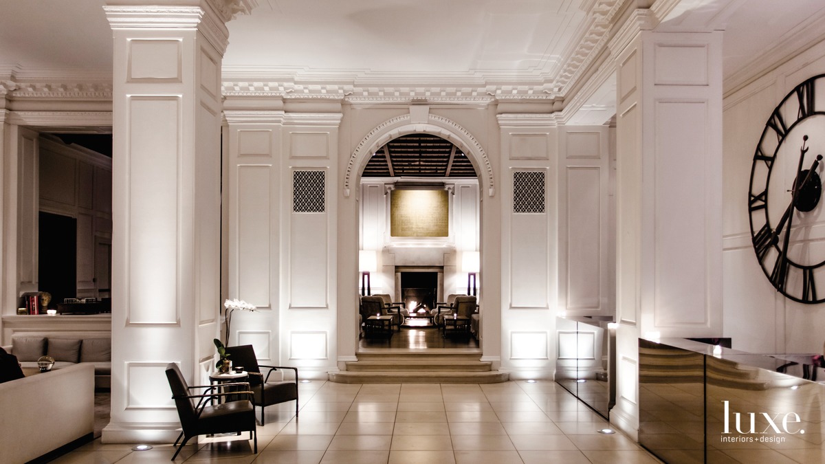 white Chicago hotel lobby with paneled walls, large clock and black guest chairs