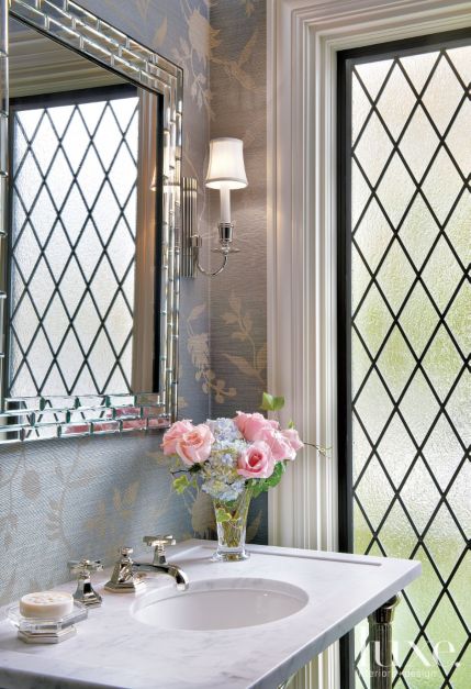 corner of bathroom with detailed windows, sink and floral bouquet