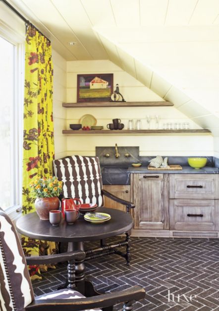bright yellow kitchen and dining area with floral curtains