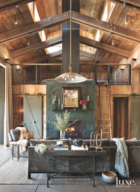 gray green barn doors in rustic wooden loft with two stories 