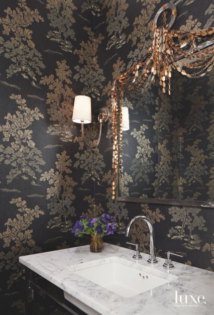 bathroom with black and gold foiling floral wallpaper, sink and embellished bathroom