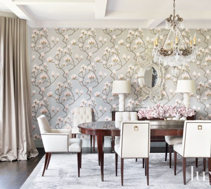 white dining area with matching chairs, lamps and floral backdrop