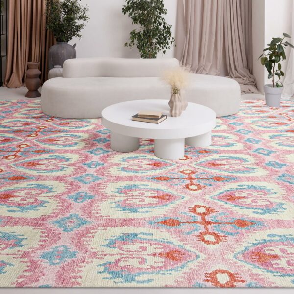 A vibrant rug in a living room, complemented by a white table.