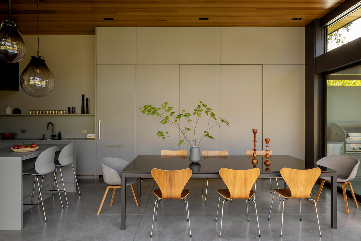 Ultra modern dining area with yellow and grey chairs.