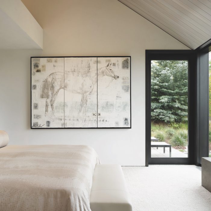 simplistic neutral bedroom with subdued artwork and black steel frame windows