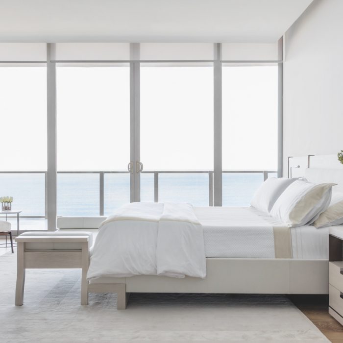 coastal inspired minimalist bedroom with whites, white wood and neutral touches