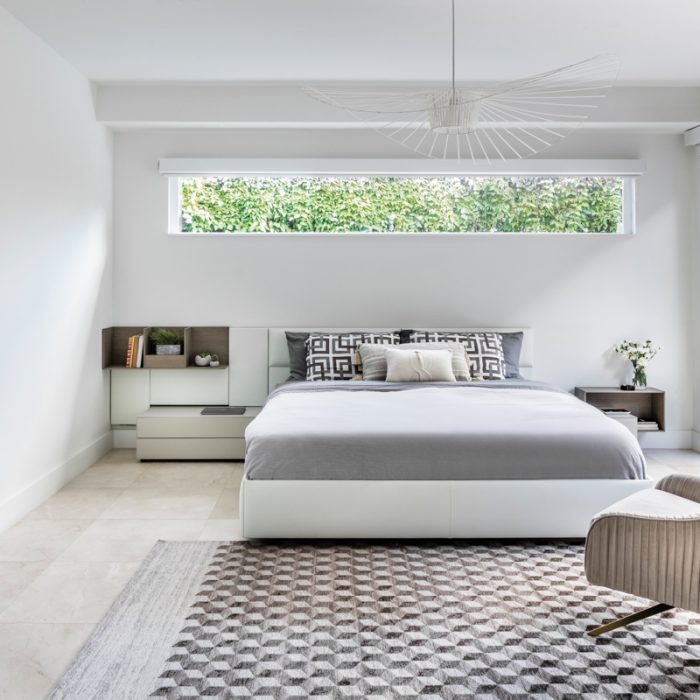 white minimalist bedroom with low bed