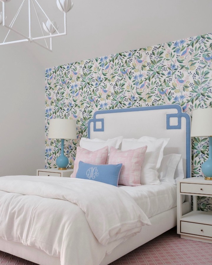 floral wallpaper, white and blue headboard, white linen in this guest room
