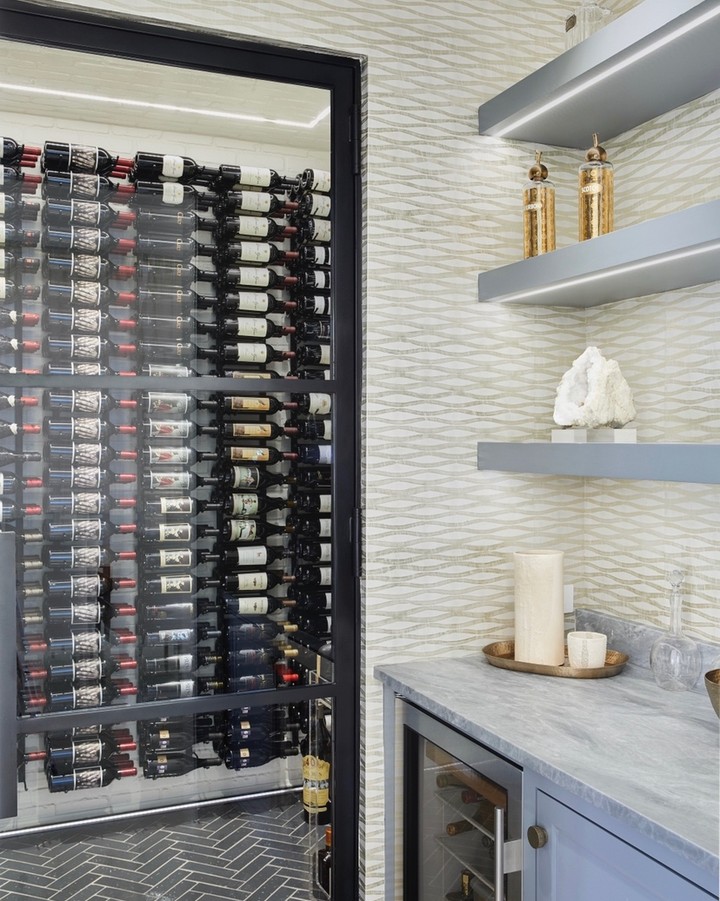 wine room and rack next to wet bar with floating shelves