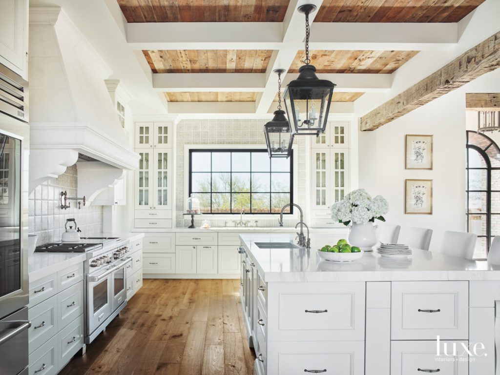 white kitchen with reclaimed beams and marble counters