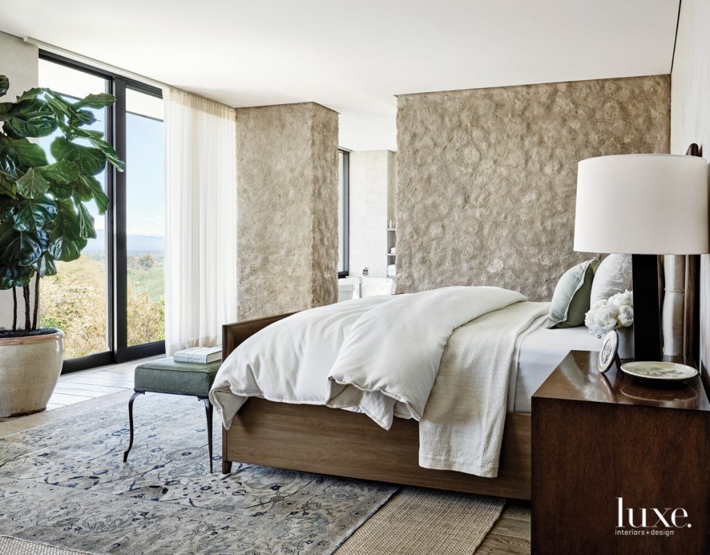 Muted colors and soft, textured materials bring a sense of tranquility to the master bedroom, where a Nancy Corzine bed looks out onto the mountains and surrounding desert. "The goal was to create a space with all the necessary comforts, but keep it at a comfortable scale," says Biegner.