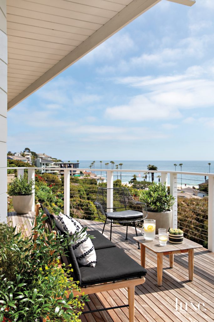 From the upper deck of their Laguna Beach home, newly renovated by architect Scott Laidlaw, David and Karin Bock can take in unimpeded views of Emerald Bay. The side chair, the settee and coffee table are all from Design Within Reach. Landscape designer Laurie Patterson, of LP Gardenworks, chose the plantings.