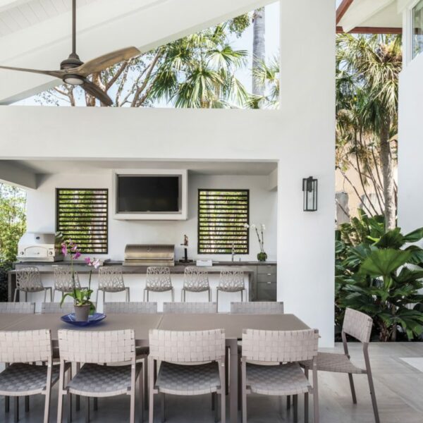 The Florida Waterfront Home Primed For Art Lovers And Outdoor Entertaining Consentino’s Dekton surface covers the cabinetry and bar from Armazem on the loggia. Sifas’ Pheniks side chairs and Kwadra dining table are from Patio & Things, where McCarthy also sourced Janus et Cie’s Forest high-back barstools. The Fanimation fan above the table and the Northeast Lantern’s Uptown lantern are from Benson’s Lighting and Fans.