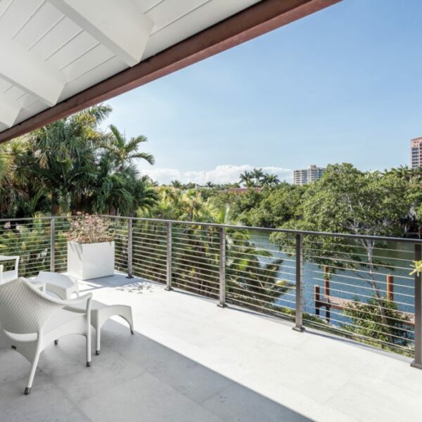 The Florida Waterfront Home Primed For Art Lovers And Outdoor Entertaining On the master bedroom’s balcony, Janus et Cie’s Amari lounge chairs flank Dedon’s Babylon side table and offer an excellent vantage point for gazing at the Coral Gables Waterway.