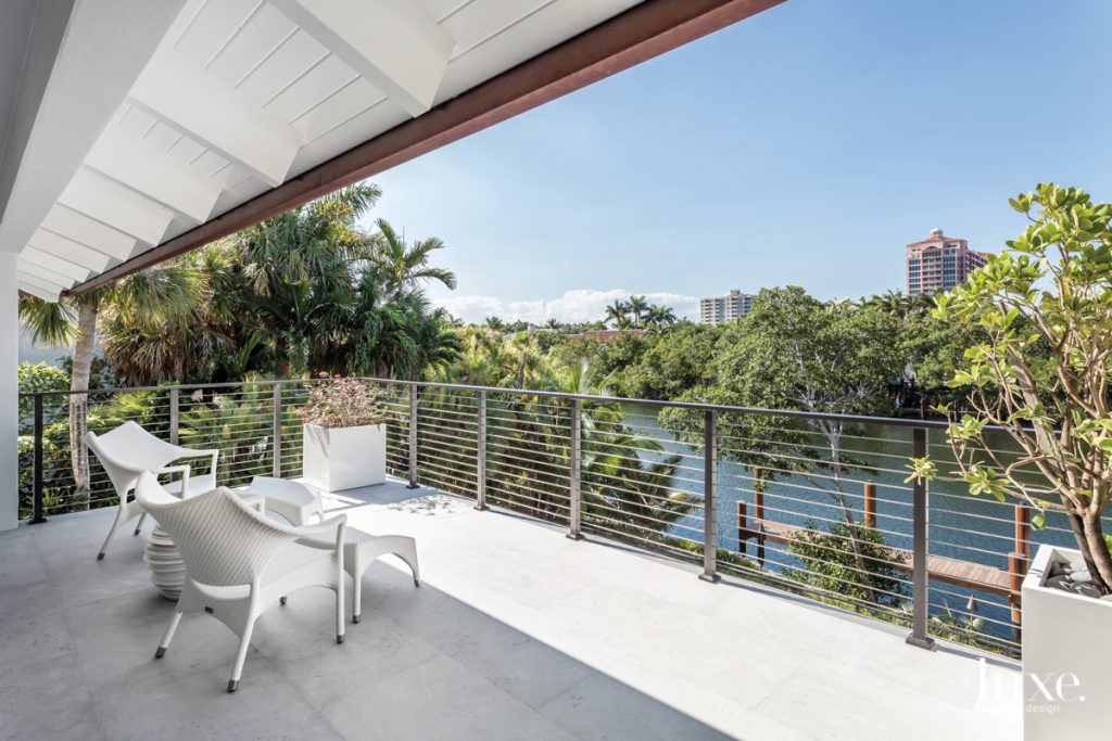 On the master bedroom's balcony, Janus et Cie's Amari lounge chairs flank Dedon's Babylon side table and offer an excellent vantage point for gazing at the Coral Gables Waterway.
