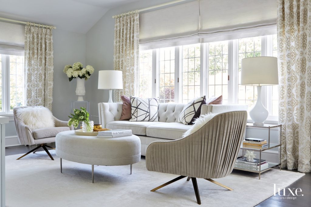 While Baker armchairs and an Emerson Bentley sofa feel classic in the living room, Alex infused modernity into the space with an Organic Modernism coffee table, a Regina Andrew Detroit chandelier and a Caroline Lizarraga painting.