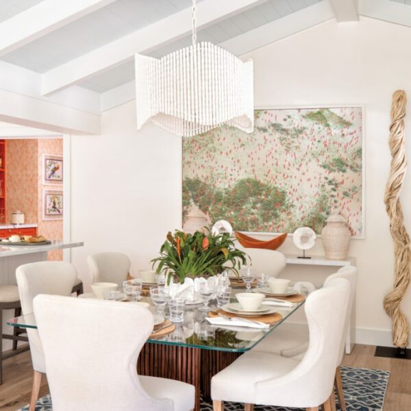 The Cheery Palm Beach Vacation Home You’ll Want To Winter In dining table with daniel beltra photograph and mother-of-pearl sideboard