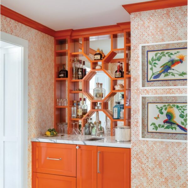 The Cheery Palm Beach Vacation Home You’ll Want To Winter In orange bar with framed vintage hermes scarves