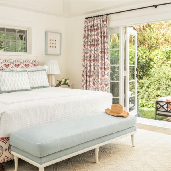 The Cheery Palm Beach Vacation Home You’ll Want To Winter In custom bed and draperies in bedroom with grasscloth wallcovering by thibaut