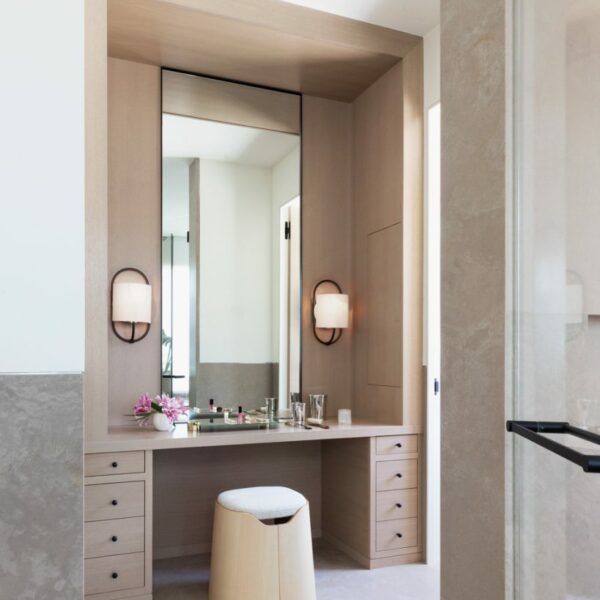 A 15-Page Survey Yields A Design That Fully Embraces This Couple’s Heritage The serene master bathroom features a makeup vanity for the wife. A Joa stool by Studio Briand & Berthereau for Ligne Roset sits in front of a mirror flanked by Bit sconces by Michael Amato for Urban Electric.