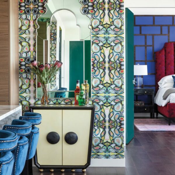 It’s All About Color In This Perfectly Orchestrated Houston High-Rise The kitchen barstools lead to a Jonathan Adler cabinet with a black lacquer frame, cream vellum wrapped doors and brass metal ball feet paired with a Bunny Williams Home mirror. The wallcovering pattern is created from sections of Lindsay Cowles’ original paintings.