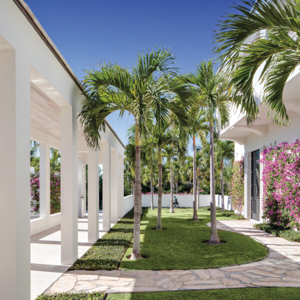 A Vero Beach Home Is A Work Of Art Inside And Outside colonnade in front yard with florida limestone cap rock