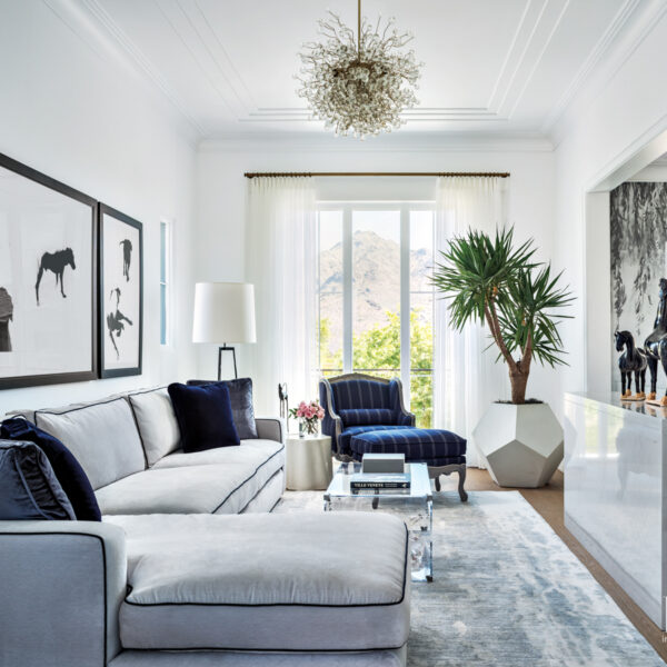 The Posh Arizona Oasis That Blends Beloved Pieces With Luxury Materials white sitting area with ralph lauren sectional and emanuel morez chandelier